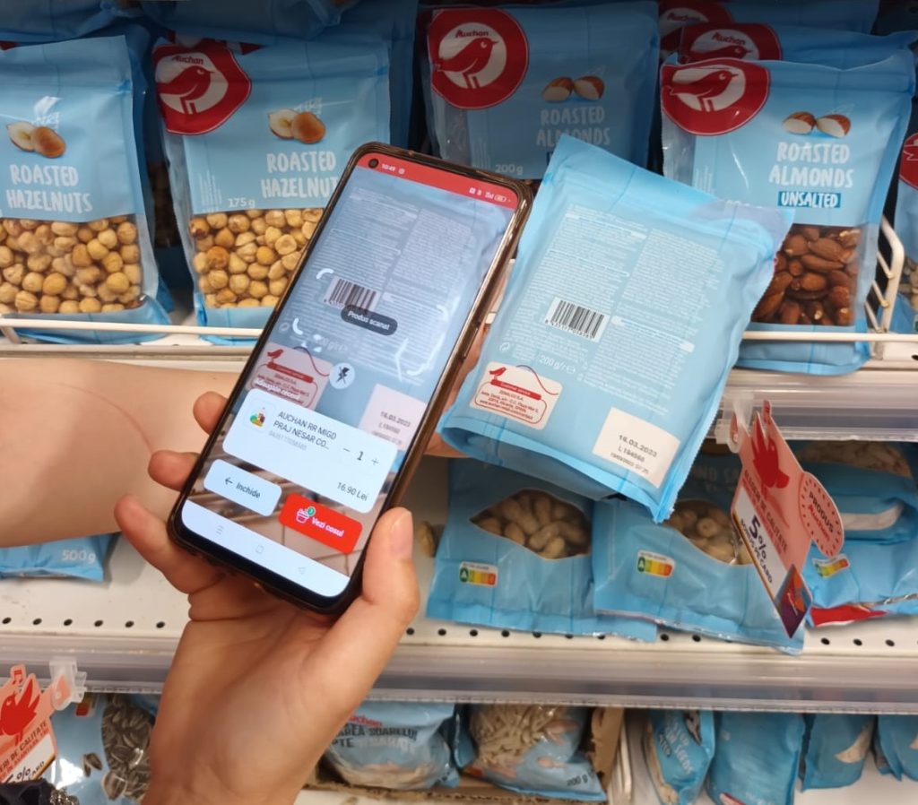 Customer scanning a product with the Auchan Romania app.
